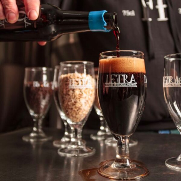 man pouring craft beer in porto