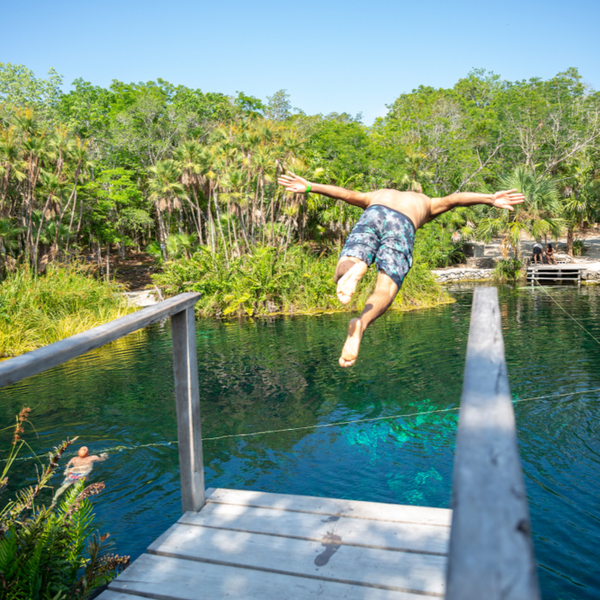 Man jumping into river in Riviera Maya
