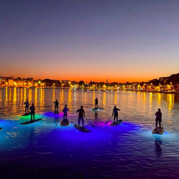 night paddleboarding with view of split