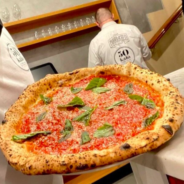 cooking traditional pizza at a restaurant in naples