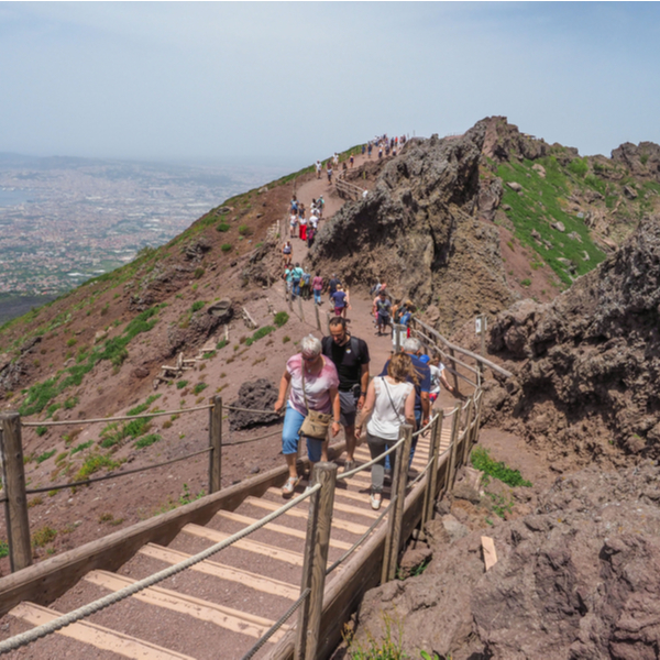 people climbing to the crater of Vesuvius volcano