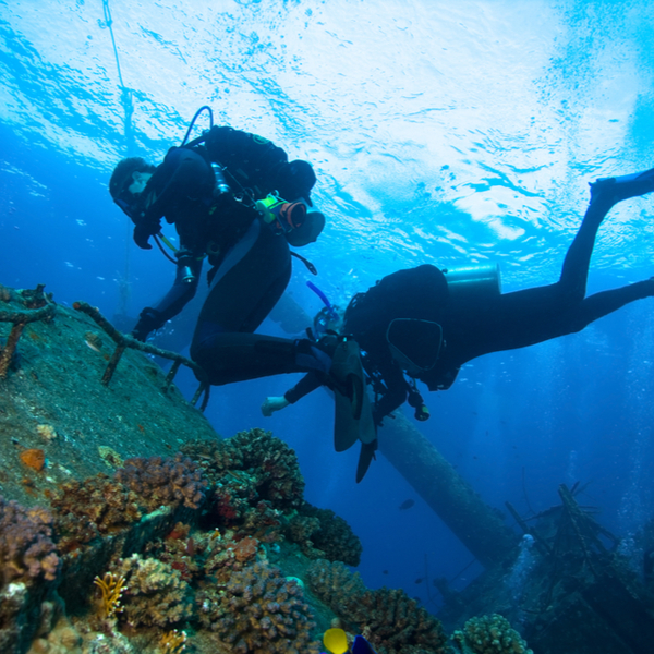 divers exploring a wreck in fiji sea