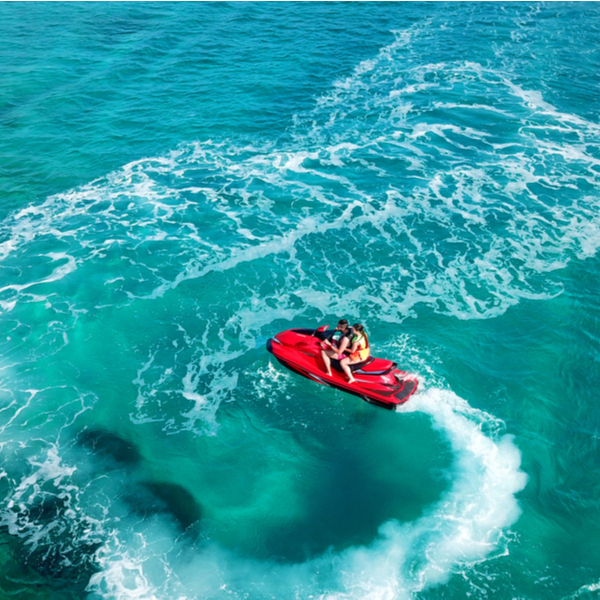 couple on jet ski at grand anse beach in grenada