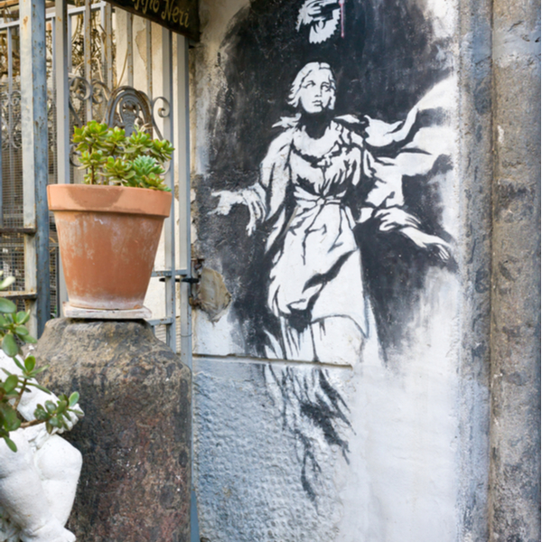 painting by banksy on a wall in naples