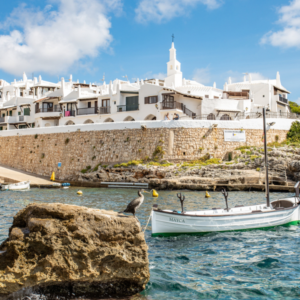 whitewashed fishing village in menorca