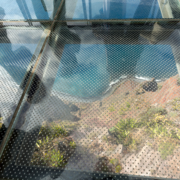 glass skywalk with view over cliffs and ocean in madeira