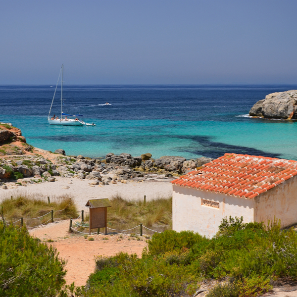 pretty bay with boat in menorca