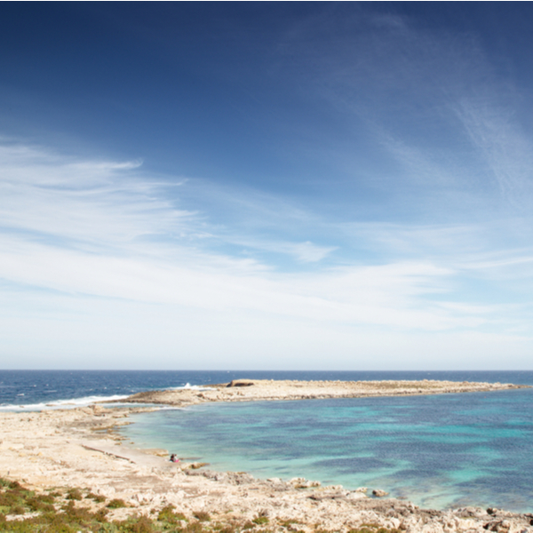 quiet stoney beach at qawra bay in malta
