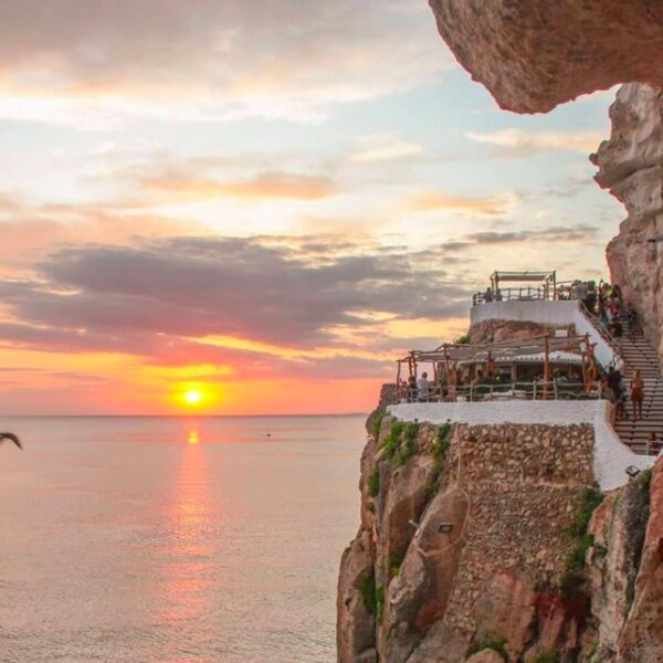 sunset at cliffside bar in menorca