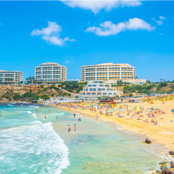 people enjoying the beach at malta's golden bay
