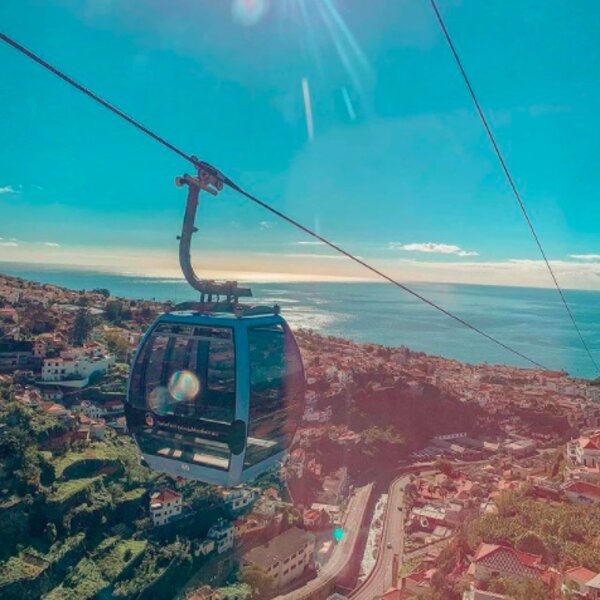 riding the cable car in madeira with a view over the city