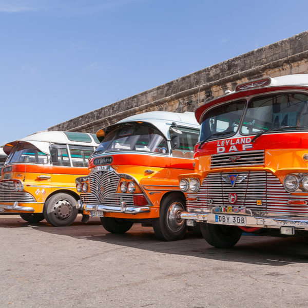 row of traditional orange malta buses