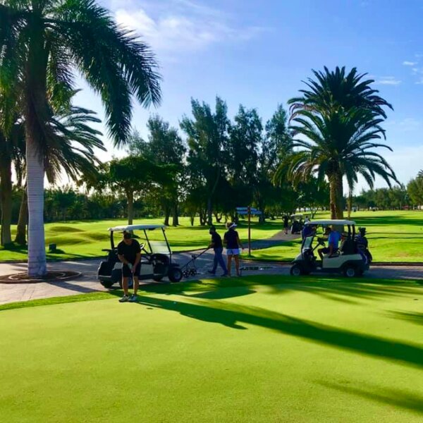 people on golf buggies at golf course in gran canaria