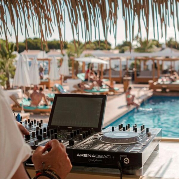 dj playing at beach club in menorca