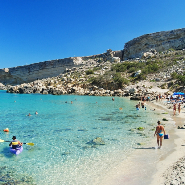 people swimming in sea at malta's paradise bay