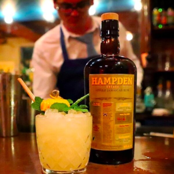 drinking rum cocktail at hampden estate in jamaica