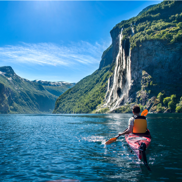 man kayaking at fjord in norway