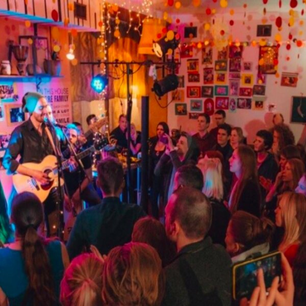 people watching live music performance at a bar in riga