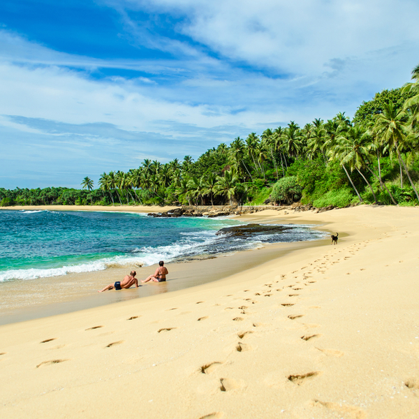 people sunbathing at Bentota Beach in sri lanka