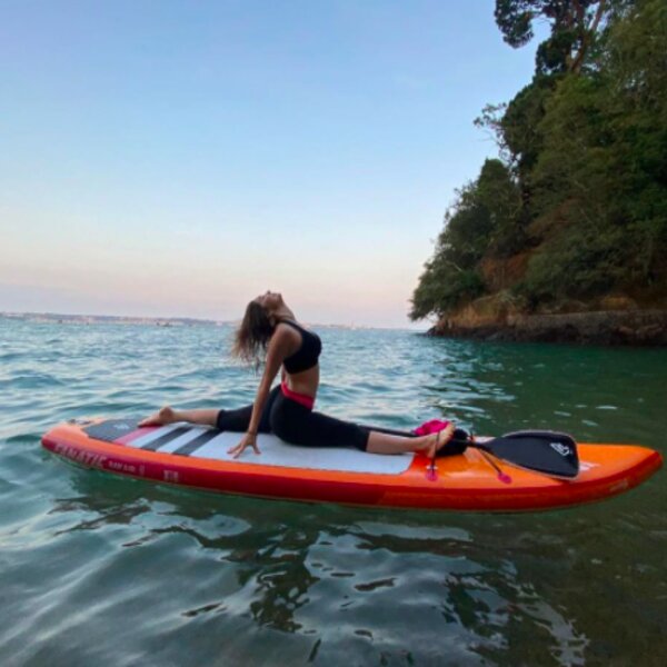 person doing yoga on paddleboard in jersey