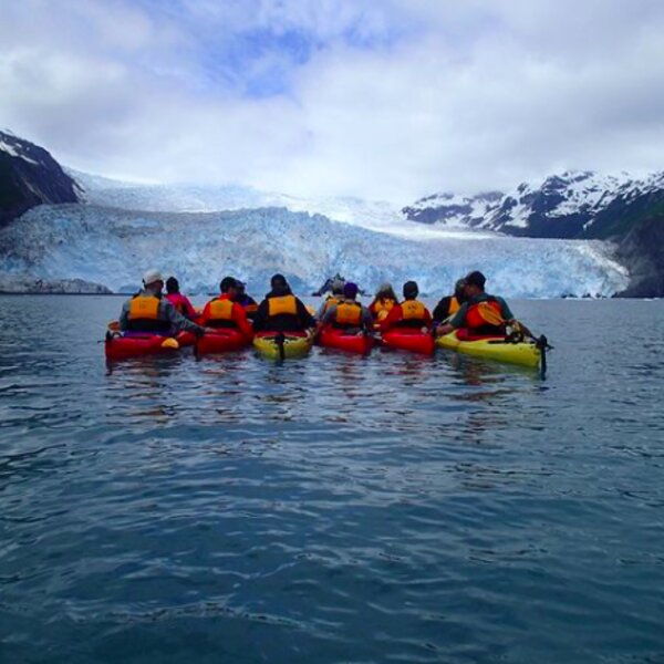 people kayaking at alaska glacier