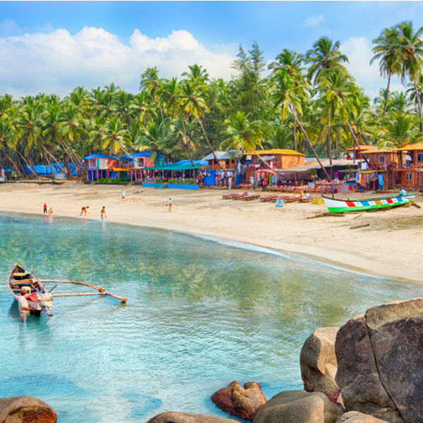 beach huts and boat on a beach in goa
