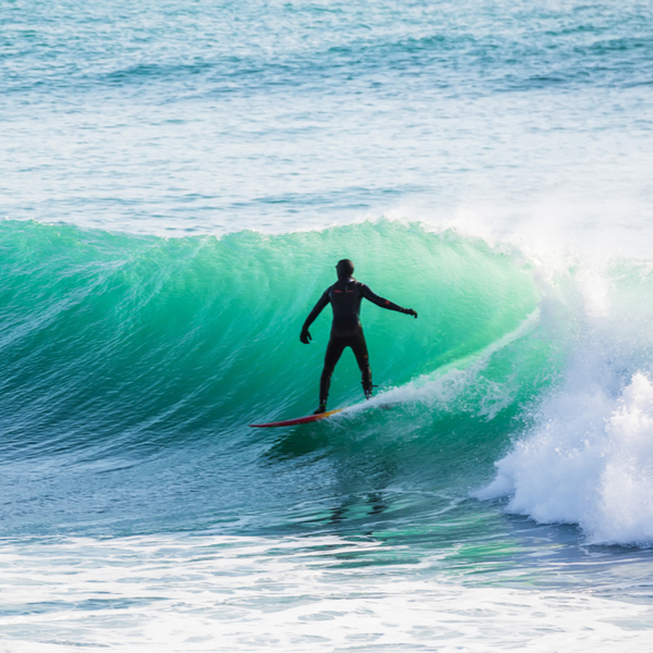 person surfing on alaskan beach