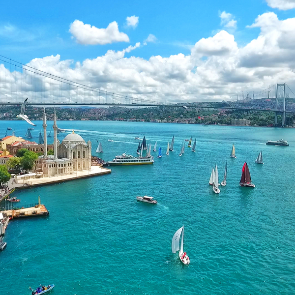 boats cruising by the bosphorus bridge in turkey