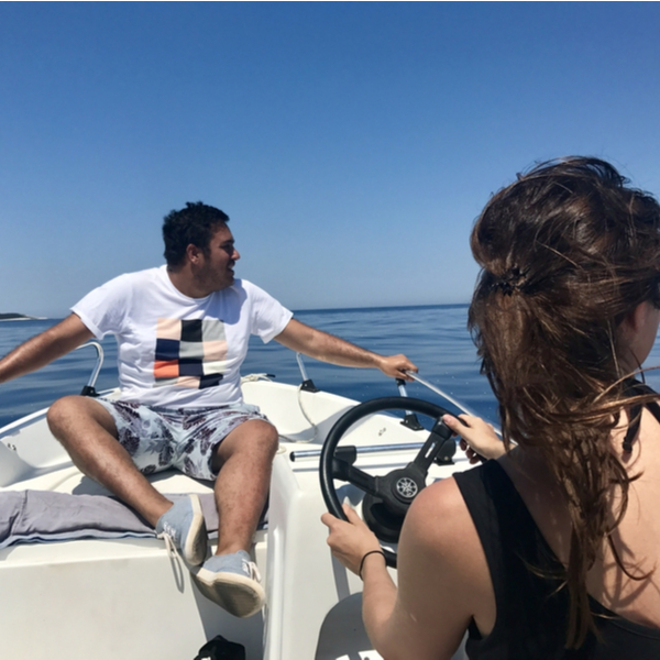 couple driving rental boat in kefalonia