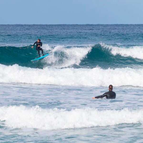 surfers at Isola Delle Femmine beach in sicily