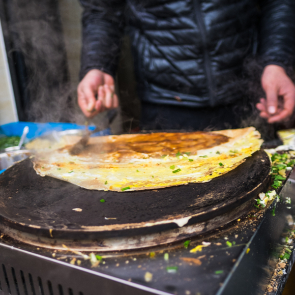 eating street food from stall in beijing