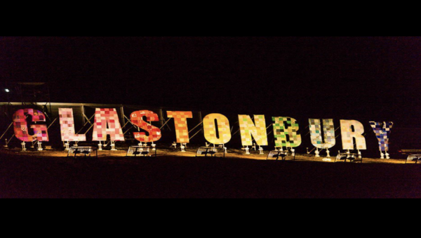 sign at Glastonbury festival at night