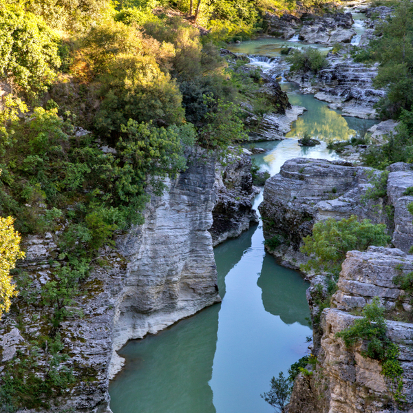 river running through cliffs in lake garda