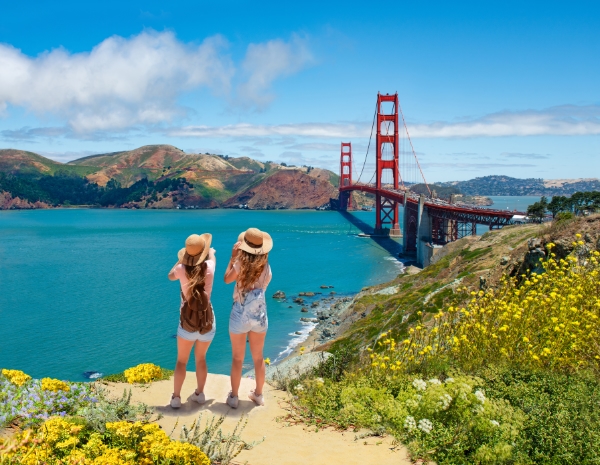 Girls looking at view over the bay and Golden Gate Bridge San Francisco