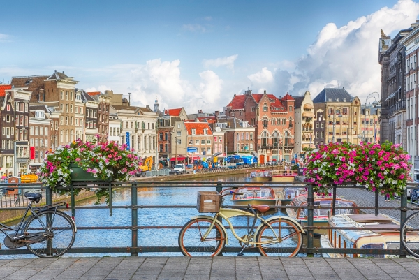 View of bikes and canal and houses in Amsterdam
