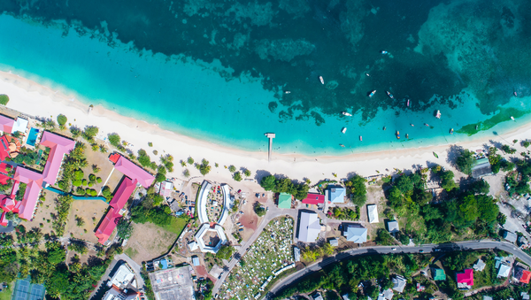 Ariel view of sea and pastel coloured homes on the Caribbean island of Grenada