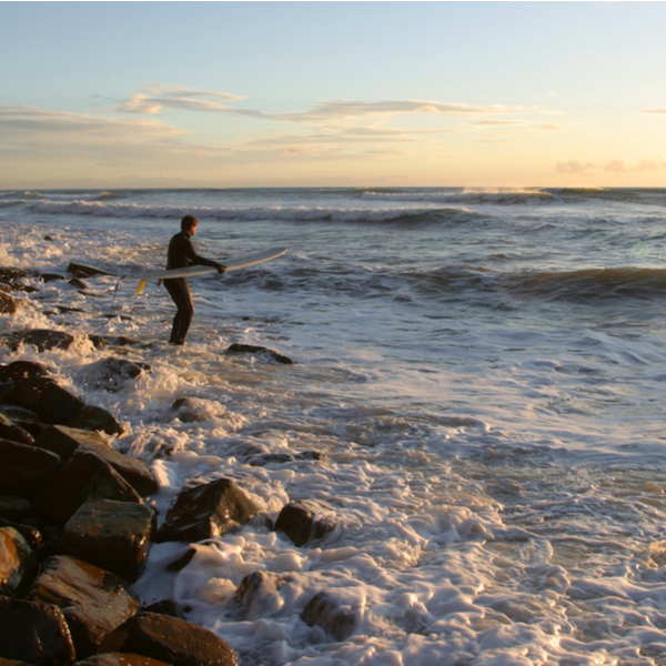 surfer at Kimmeridge Bay