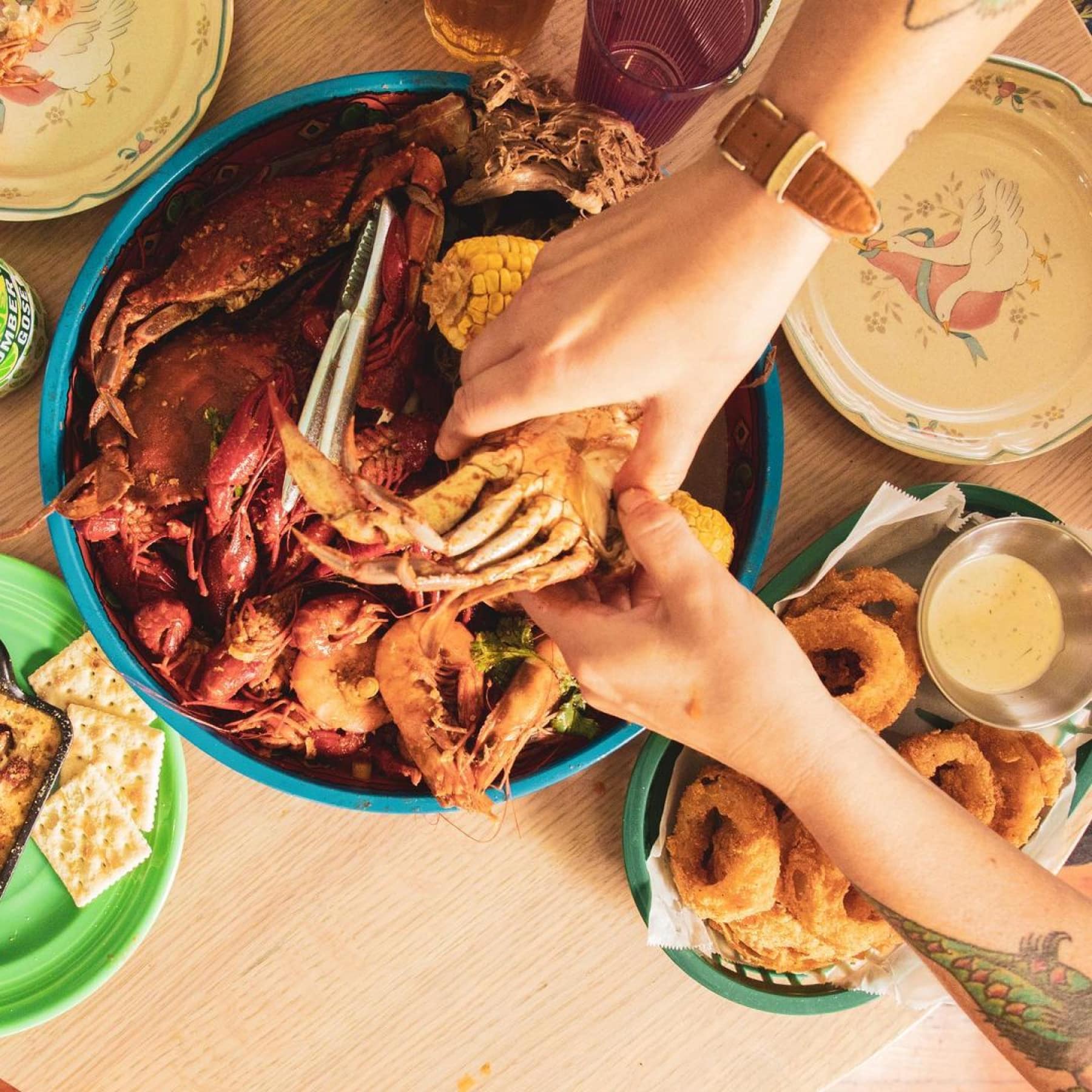 Bowl of seafood and another bowl of sides at Seafood Sallys