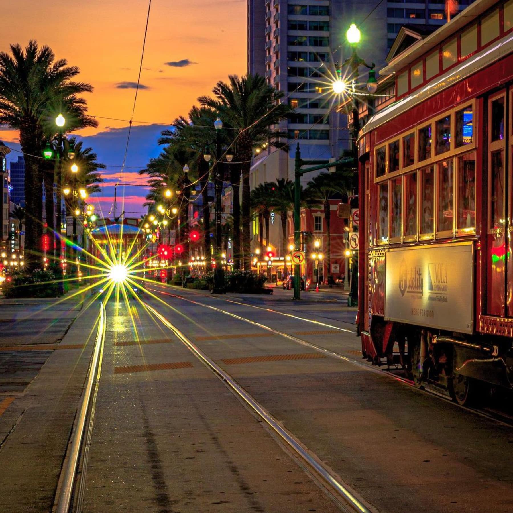 Tour tram on a sunset street of New Orleans