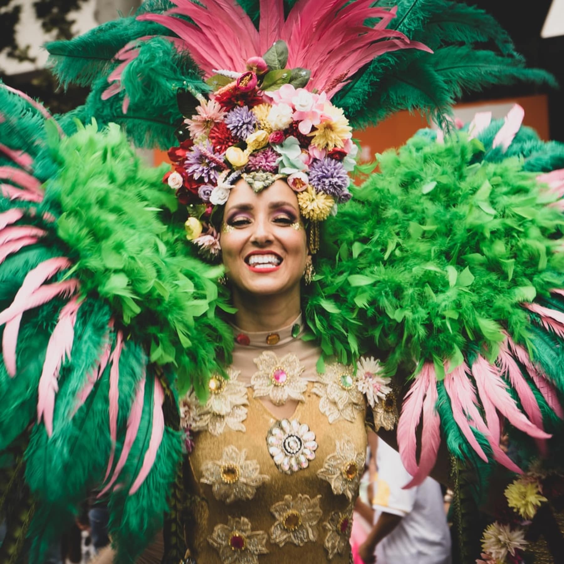 Lady celebrating Mardi Gras in green feathers