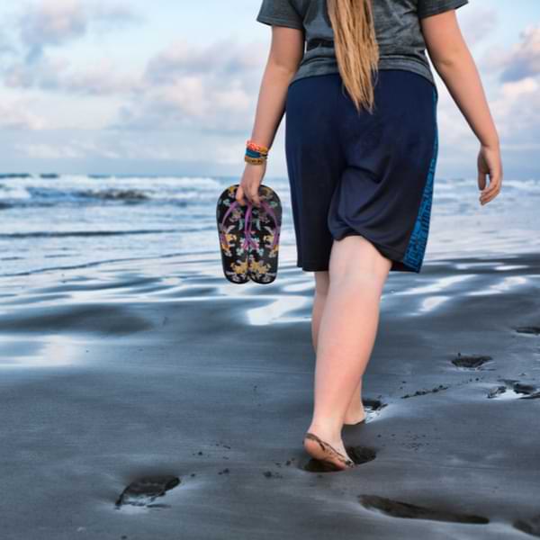 woman dressed modestly at oman beach