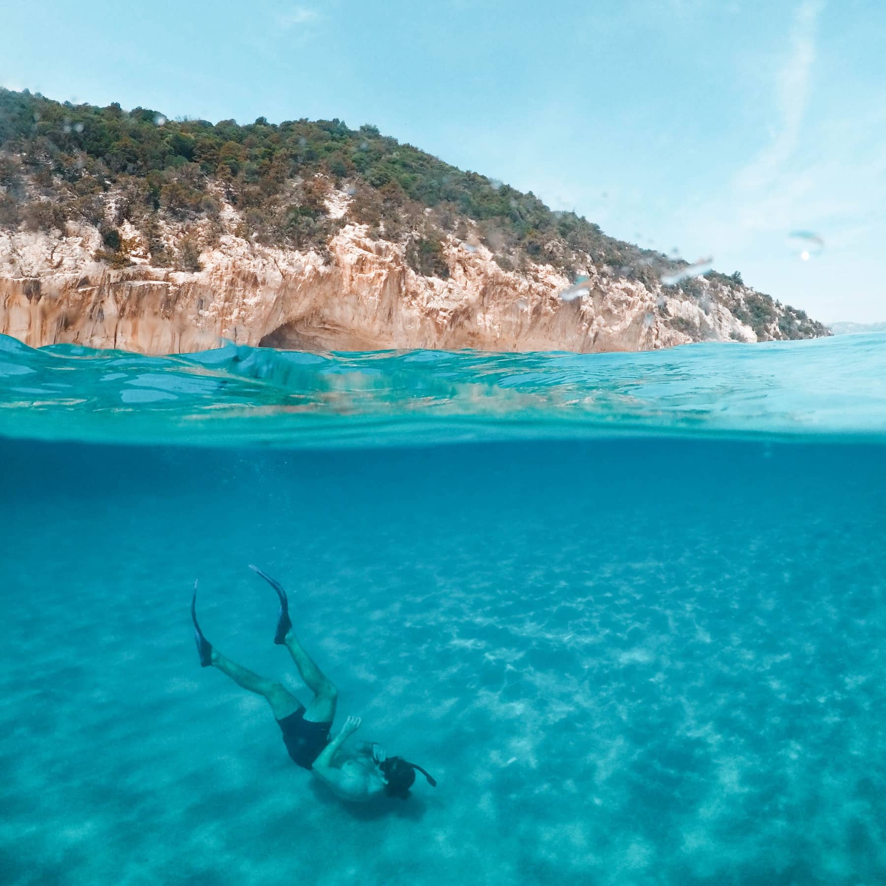 Diving in the Seychelles. Snorkellling in the blue waters of the Seychelles with the green trees on the rocks as back drop