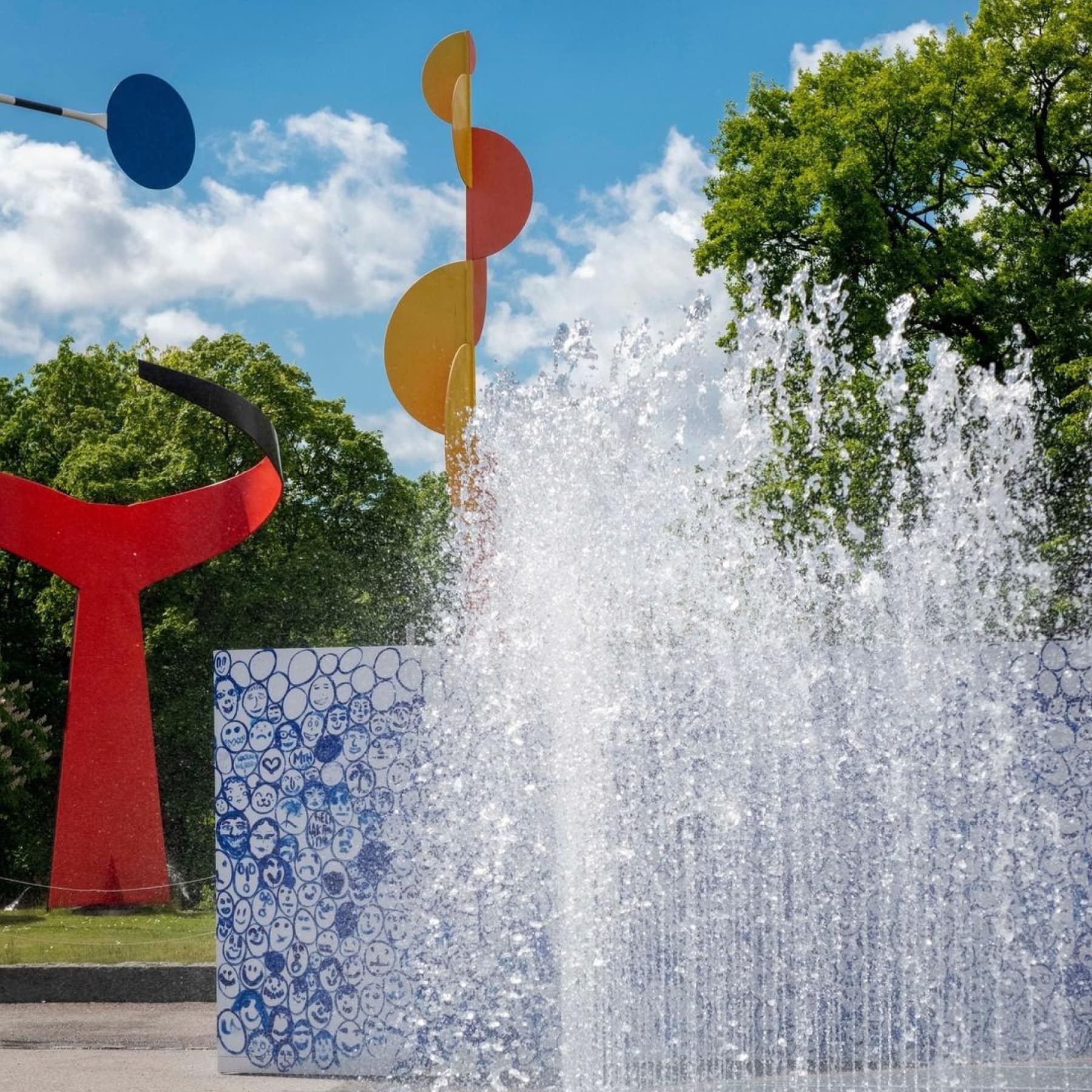 Water fountain splashing outside the Moderna museum with artistic sculptures in the background