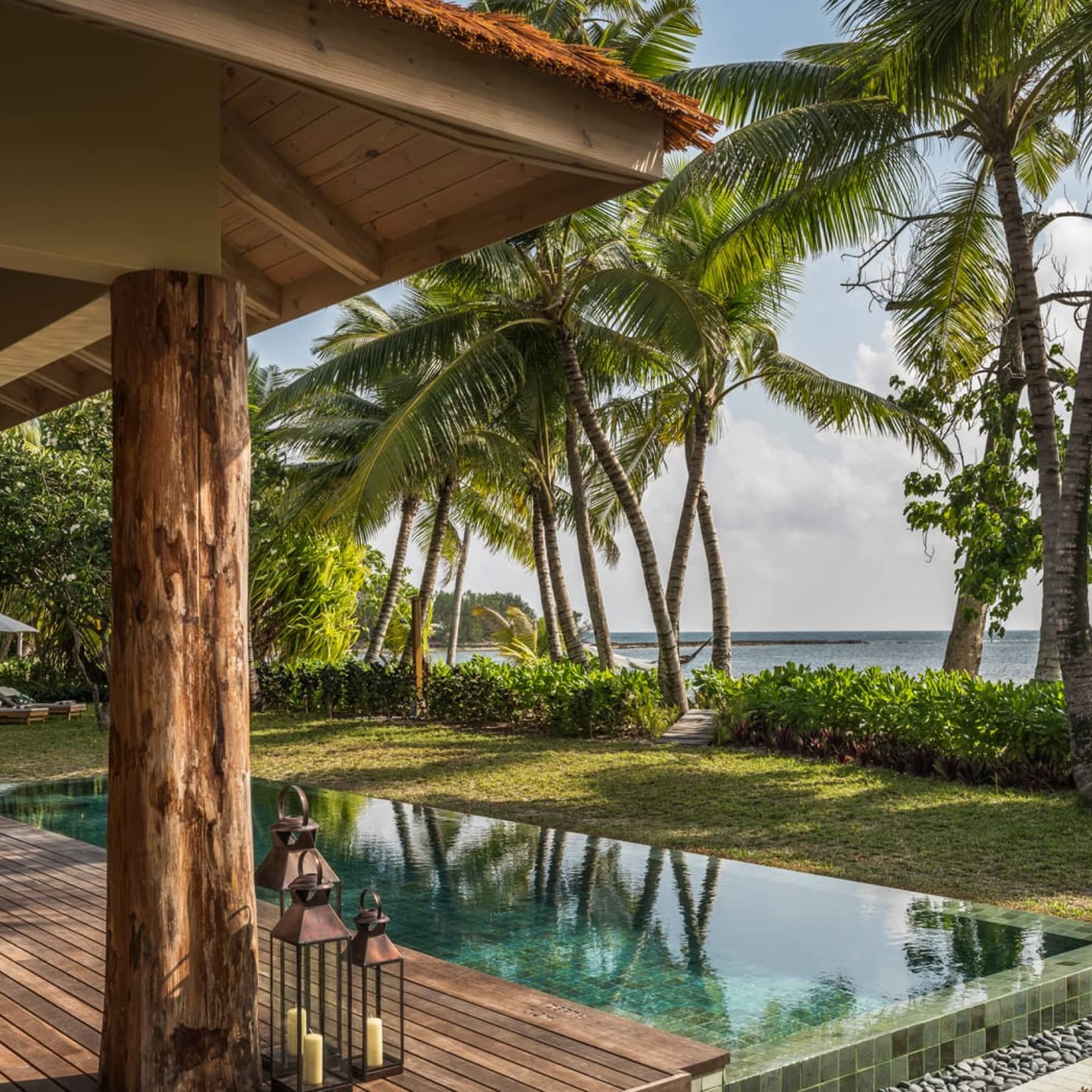 A private garden lies before the beach, equipped with a private pool at the Four Seasons Resort Seychelles Desroches Island