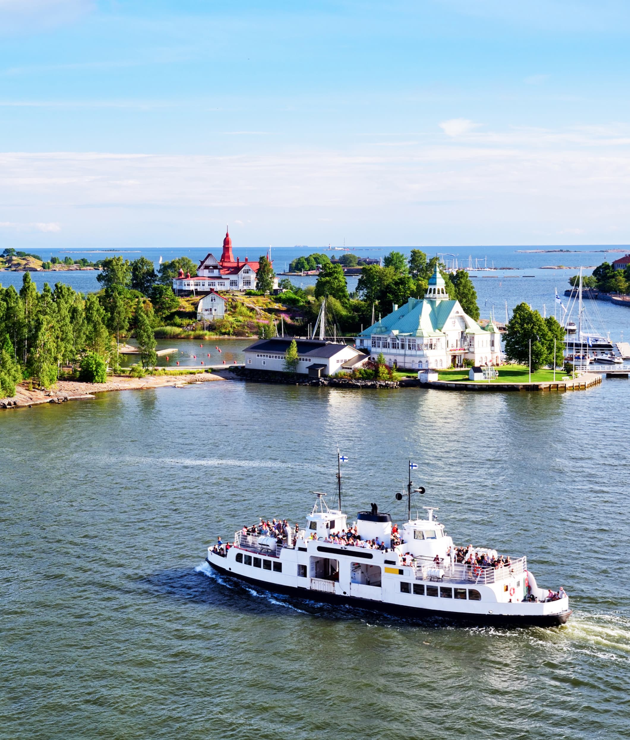 A boat travels across the waters of Helsinki