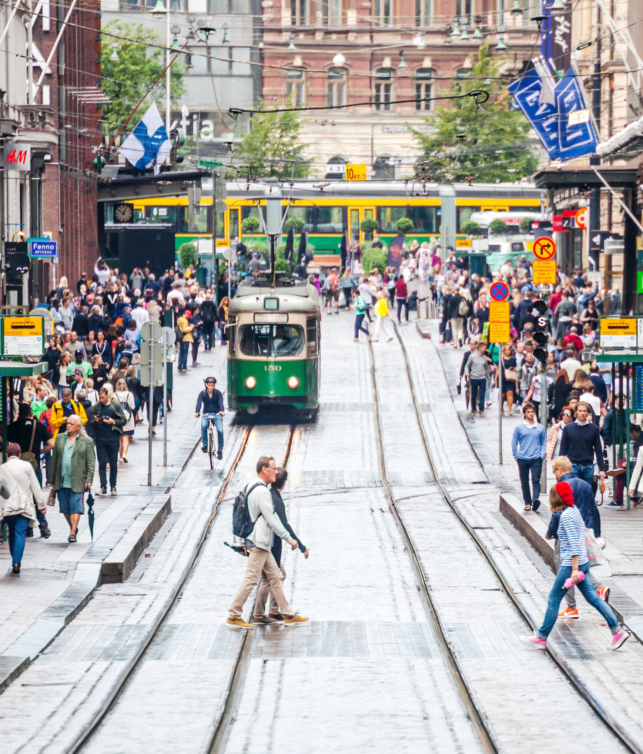 Th streets of Helsinki, filled with people and a busy tramline