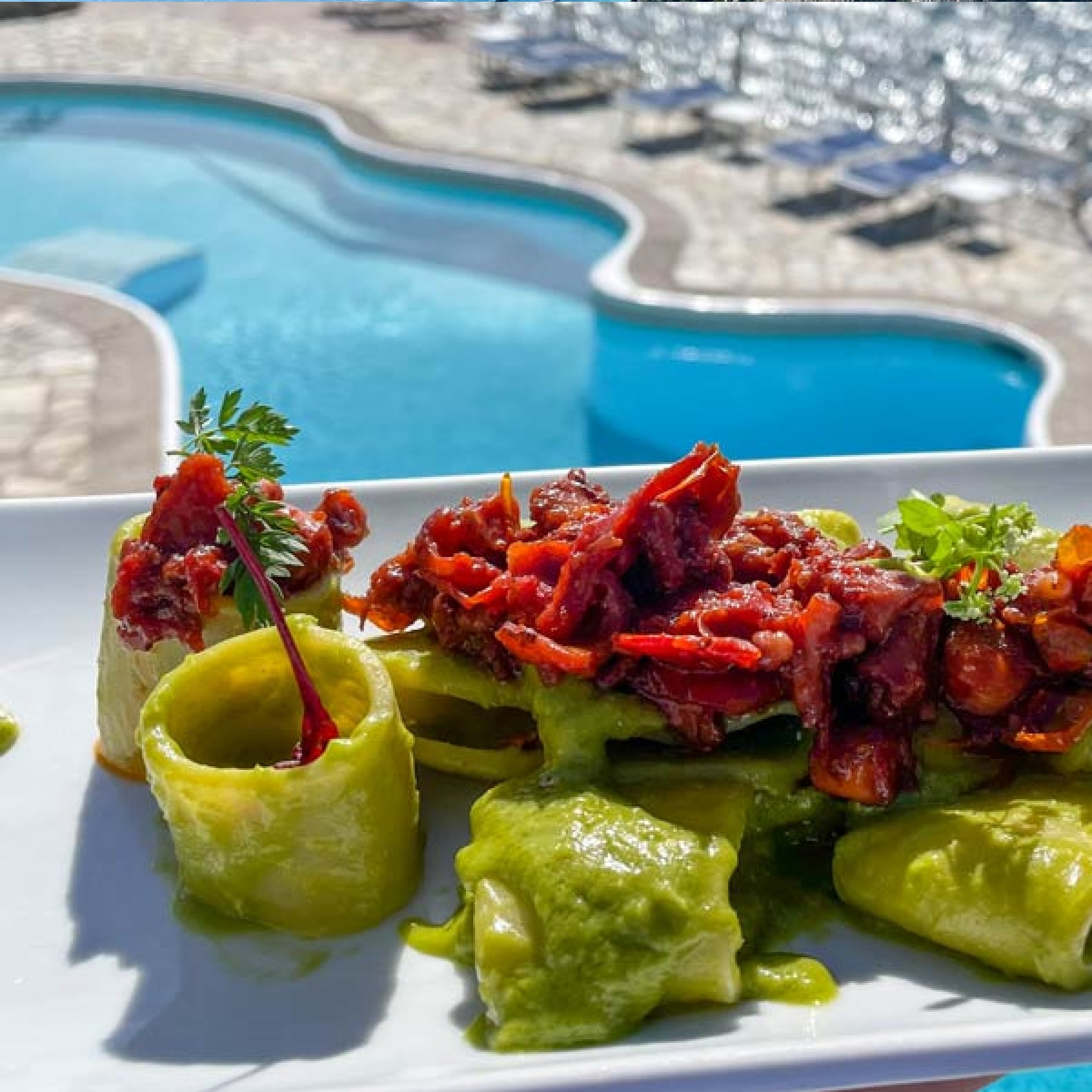 pesto pasta by the pool and sea