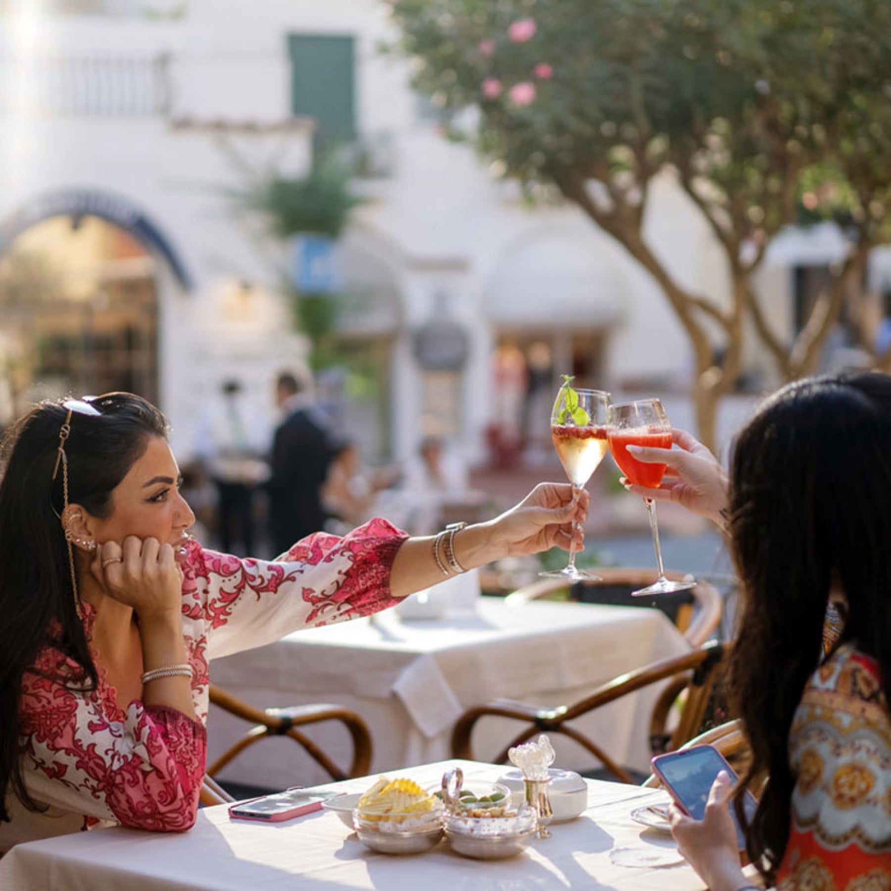 Ladies cheers to their meal at Quisisana
