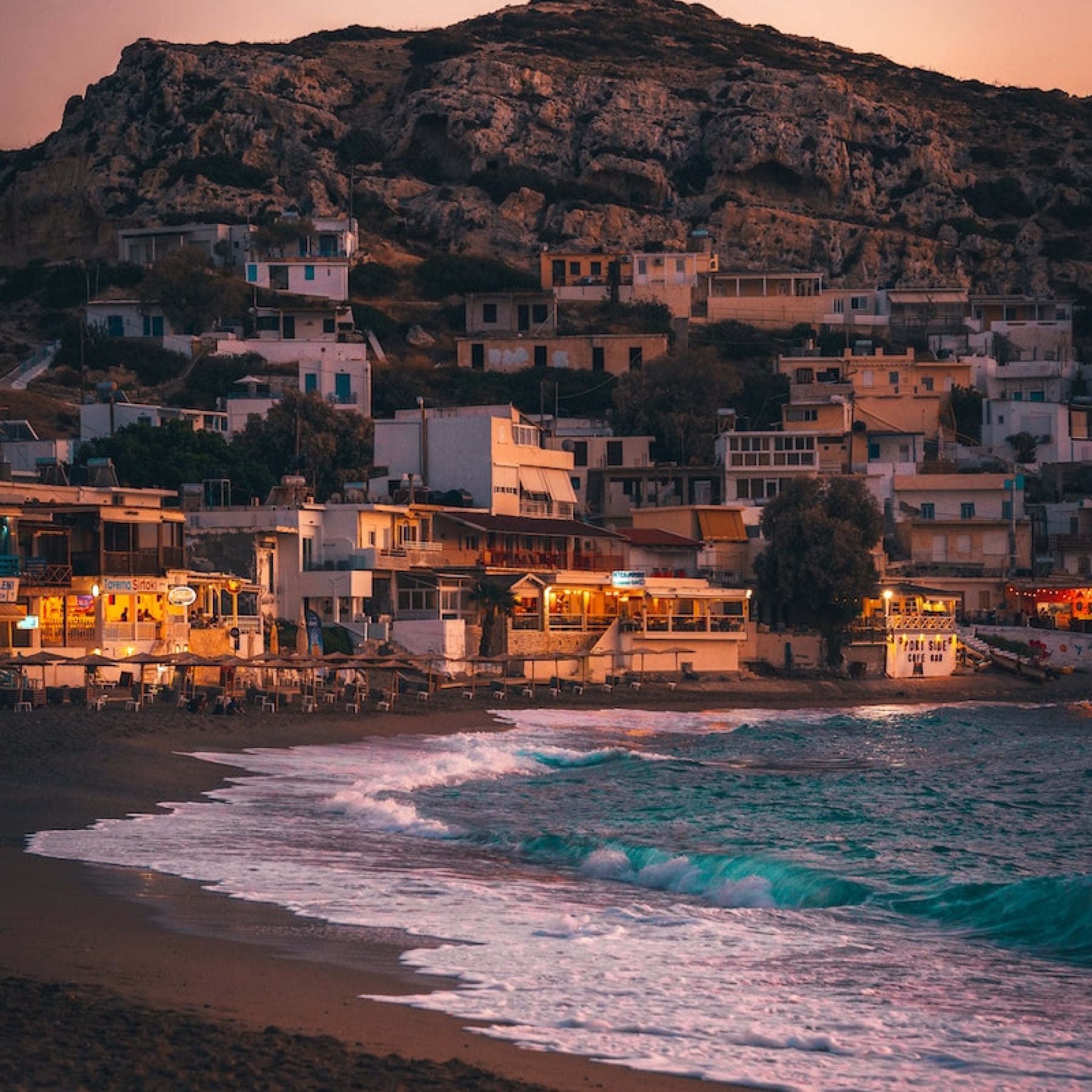 Streetlights begin to light up the coast of Crete